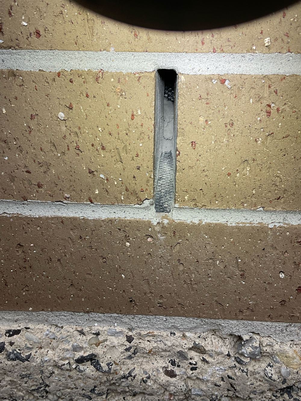 Weep holes obstructed by mortar, recorded on a fixing stage inspection in Fraser Rise