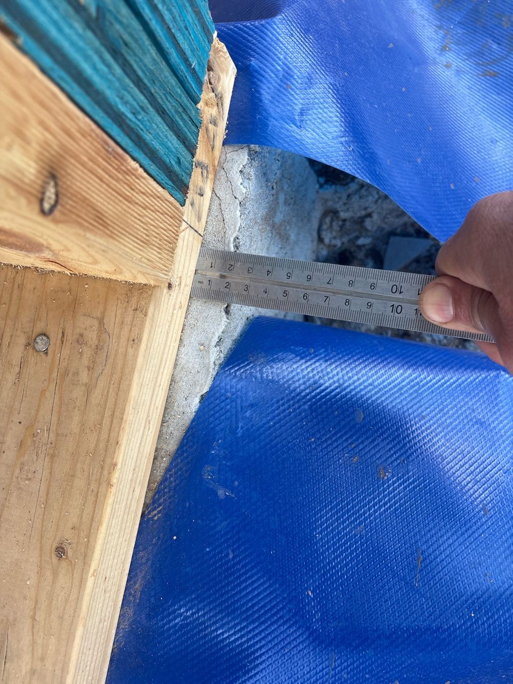 Slab protruding beyond the timber wall, recorded on a frame inspection in Fraser Rise
