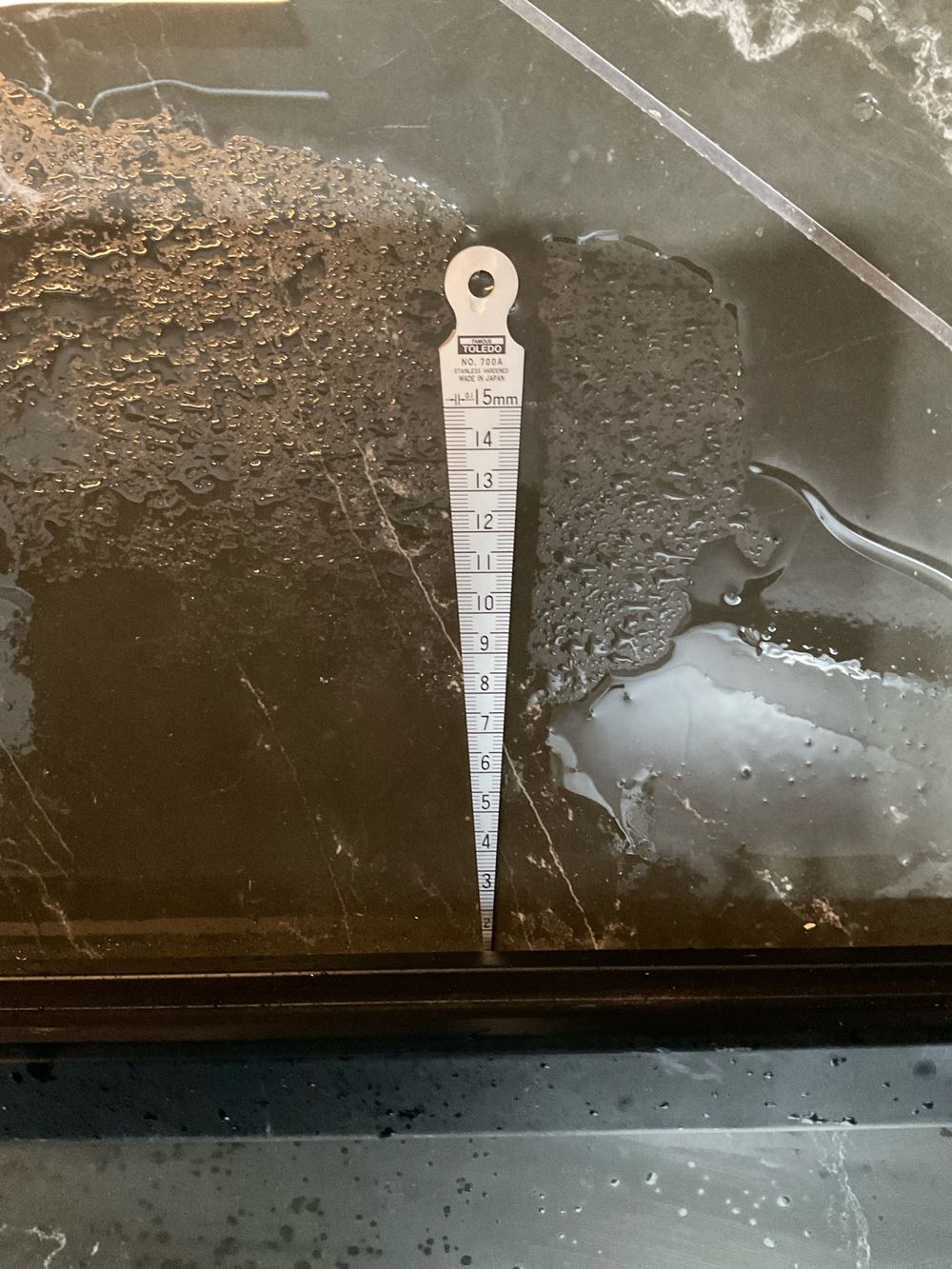 No waterstop installed under a shower screen, recorded on a pre-handover inspection in Fraser Rise